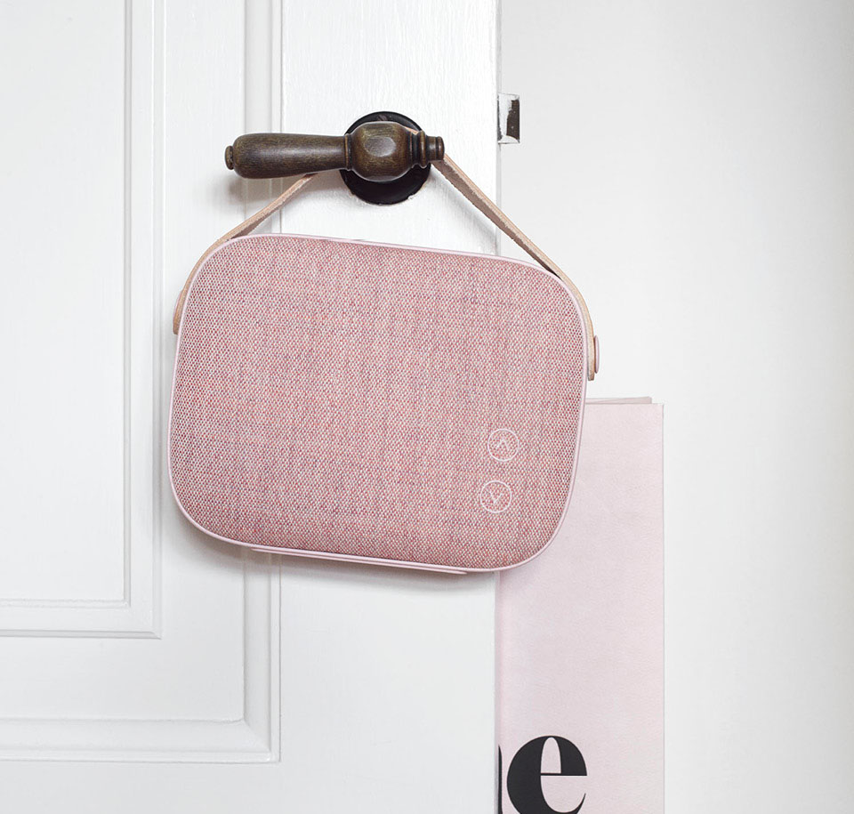Pink Helsinki Speaker Hanging from a White Door's Brown Handle