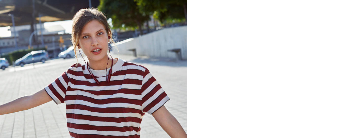 A girl wears JBL Live 220 Bluetooth In-Ear Neckband Wireless Headphone