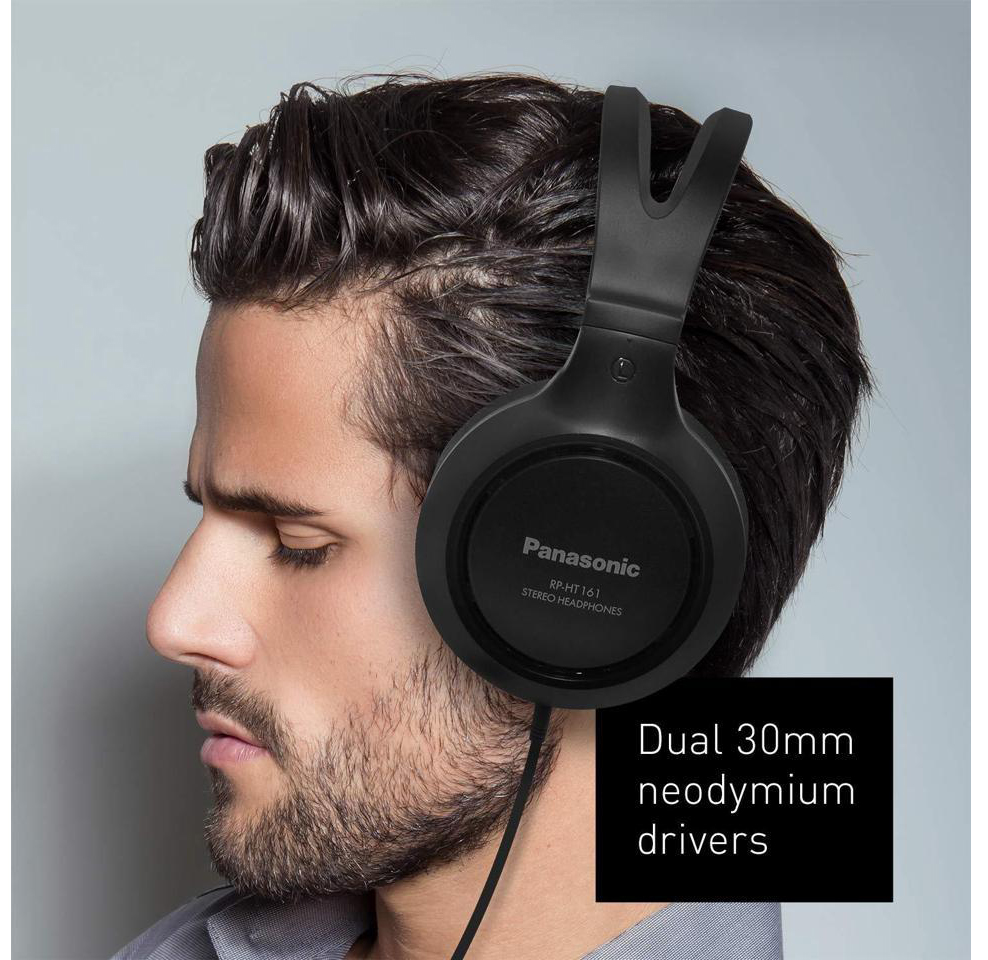 A man wears Panasonic Full-Sized, Lightweight Long-Cord Headphones