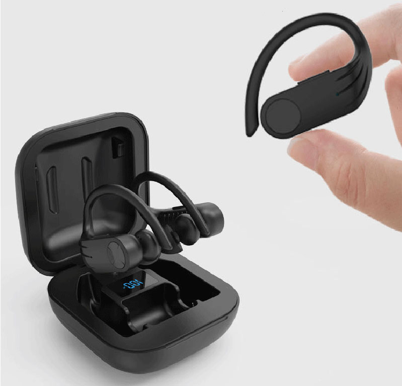 a hand holding a singel earbud near the charging case where two earbuds are inside