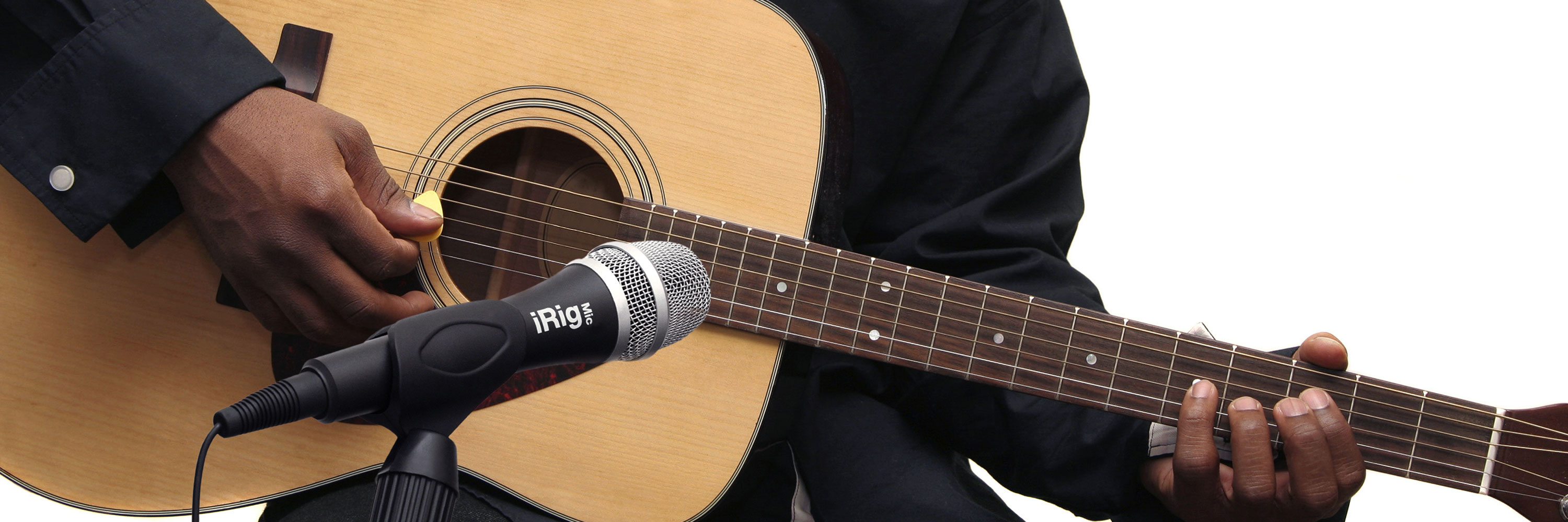 A Guitarist Playing His Acoustic in Front of the iRig Mic
