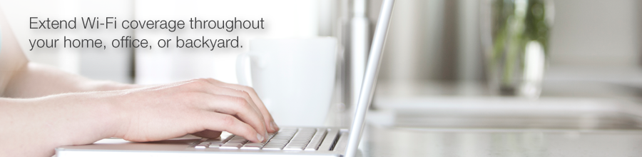 Hands using a laptop in a home with text that reads: Extend Wi-Fi coverage throughout your home, office or backyard.