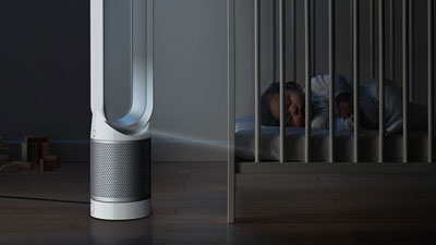 Dyson Pure Cool Link beside baby in a cot   