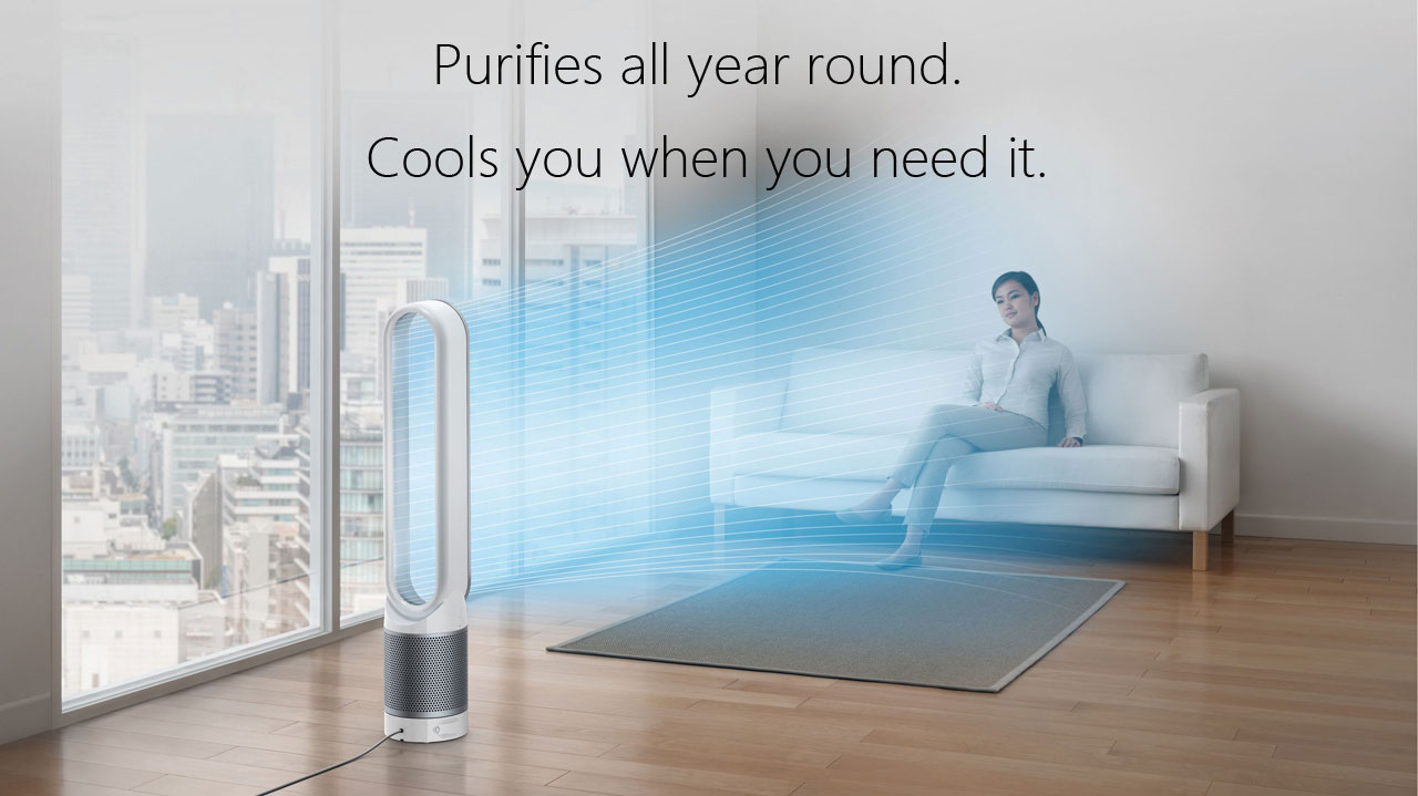  A Dyson TP02 Pure Cool Link tower purifier fan delivering cooling, purified air to a female sitting in a couch in a living room, with texts at top center reading as 