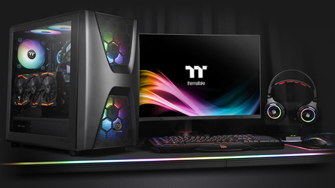 Thermaltake Commander C34 Case Fully Loaded with components next to a gaming monitor, keyboard, headphones and mouse