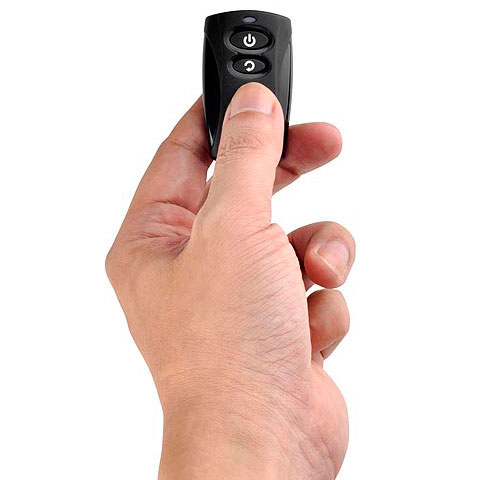   The remote pinched by thumb, index finger and middle finger 