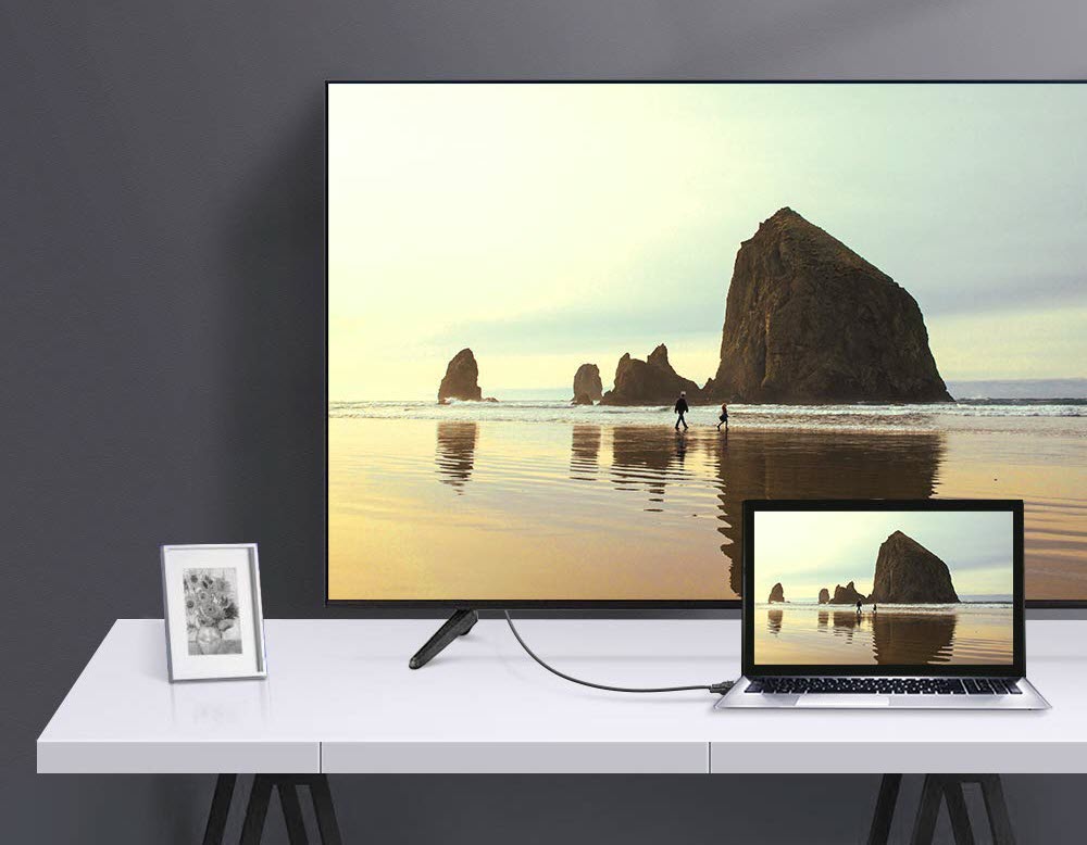 a laptop connected to a TV via the cable