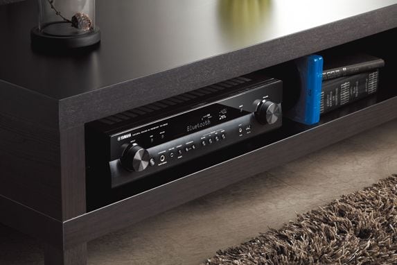 Yamaha RX-S602 Slimline 5.1-Channel AV Receiver is placed in the bookcase.