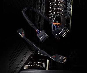  Closeup of two extension cables, with motherboard pin headers in the background  