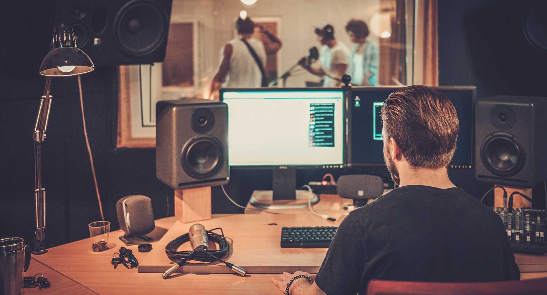 a man is working with a set of computer in a home audio studio