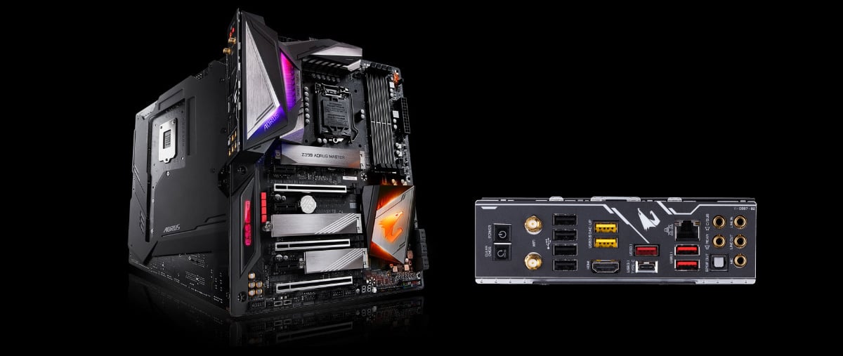 AORUS Z390 motherboards standing up, one facing forward, angled to the right, and the other facing away to the right. Next to these motherboards is the I/O panel of the motherbaord