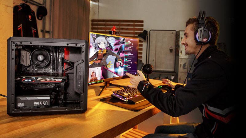 a man is happily playing games on a MSI gaming desktop