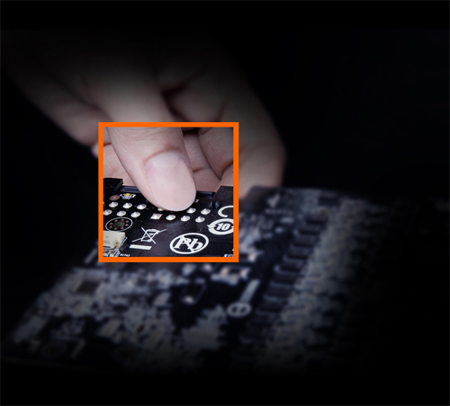 An image shows a hand pick up the circuit boards