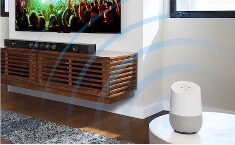 Google Home is on a desk emitting sound wave.