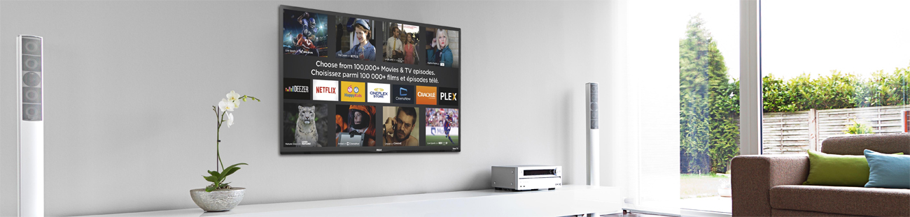 The RCA RTRU5028-CA TV mounted on a wall of a white and gray-colored modern-home living room