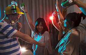 Men and women dancing in a hotel-room party