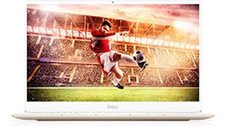 a Dell laptop showing a soccer player kicking the ball