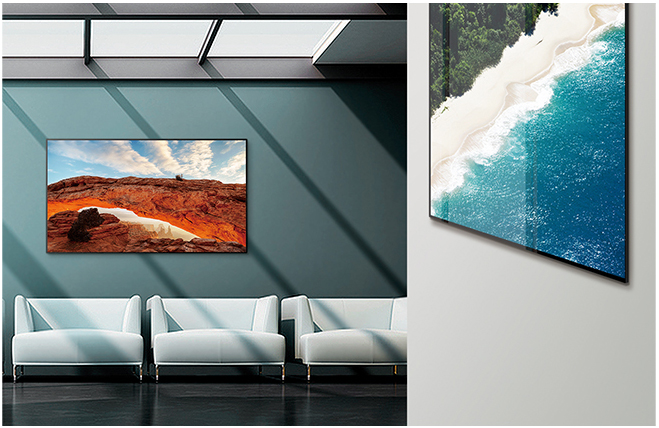 A modern-decor waiting room with 2 LG commercial displays. One shows a desert canyon and the other an island beach.