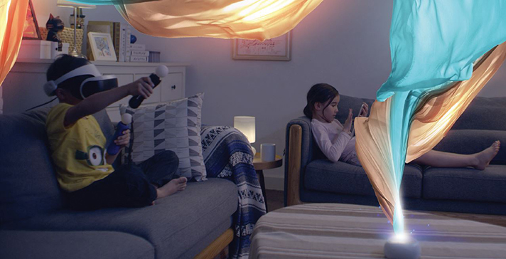 two children playing in their living room, the boy is using playstation VR and the girl is using a tablet