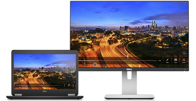    Front view of an opened Latitude E7450, with a Dell monitor next to it on the right. Both of these two device displaying the same picture of a night city landscape