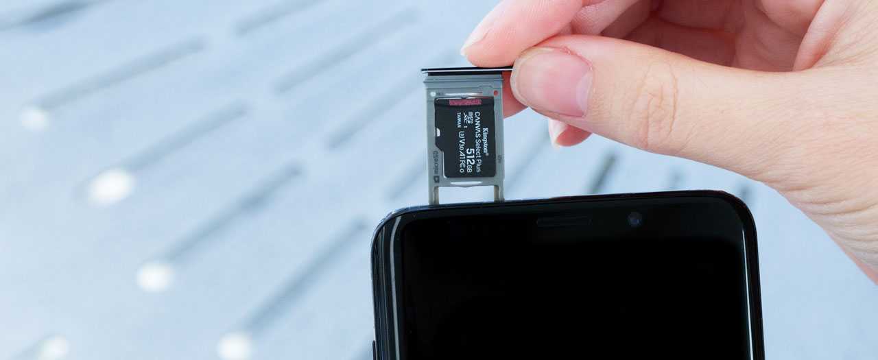 A 512GB card in a microSD card tray of a mobile phone  