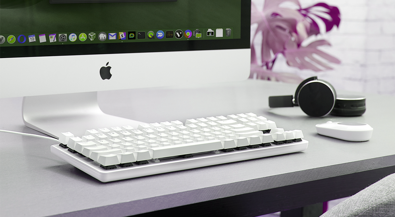 a computer, a white keyboard, a phone and a mouse