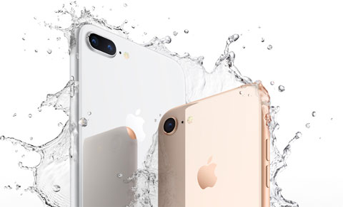  Rear view of upper part of iPhone 8 and iPhone 8 Plus, surrounded by splashes of water  