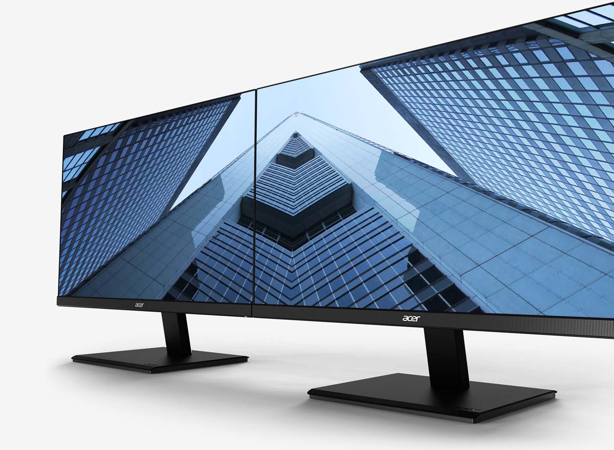 Two ACer V277U Monitors Side by Side, Angled to the Left both sharing an image of large glass skyscrapers being viewed from the ground up