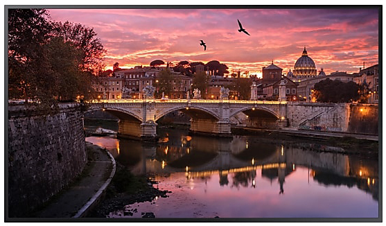 Samsung TV Facing Forward Showing a Bridge Over Water with a City at Twilight Hour and Birds Flying in the Sky