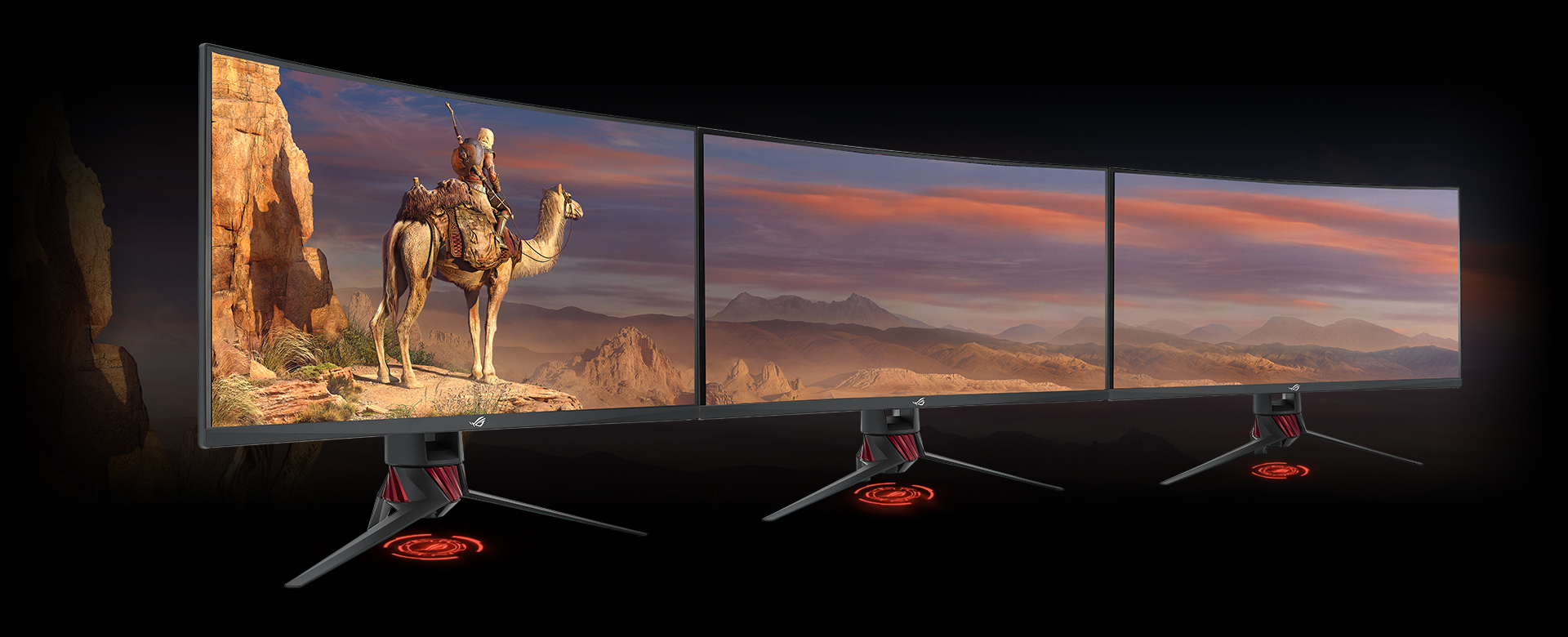A Set of Three Monitors Side by Side, Forming a Connected Display with a desert scenery
