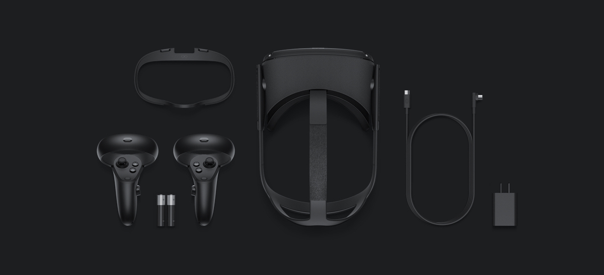 Oculus Rift S Gear lying down flat, the controllers, two AA batteries, the visor equipment, cable and outlet adapter
