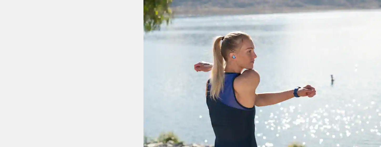 A girl wears JBL REFLECT FLOW True wireless sport headphones