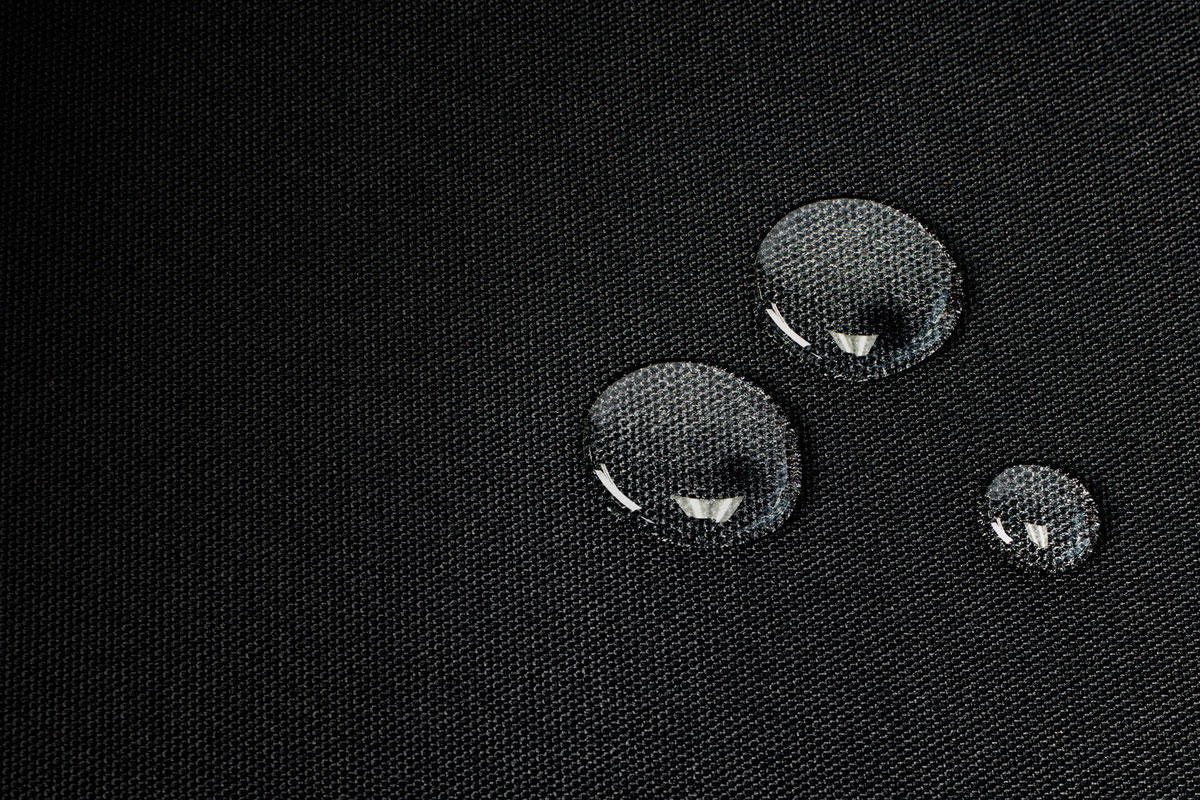 Closeup of three water droplets on the cooler master mp510 gaming mouse pad