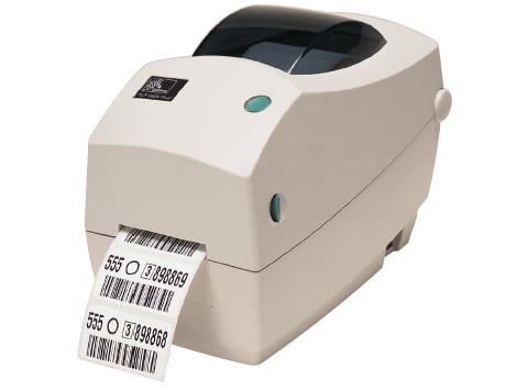 Zebra TLP2824 Printer Angled Down to the Left with Barcode Paper Coming Out of It