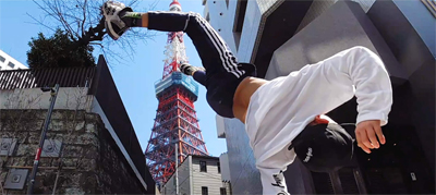 A young man performing a parkour flip being filmed by a stationary Osmo Action