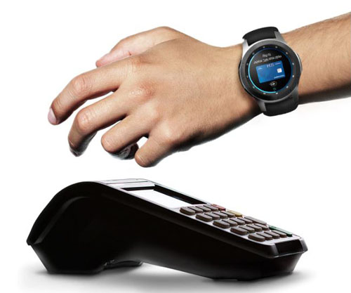 A hand with watch on is next to POS device