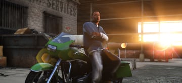 A man posed by sitting on a motorbike inside a warehouse