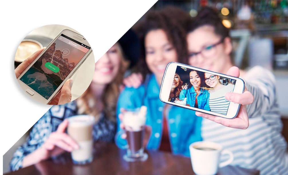 A group of friends at a bar taking a selfie with a smartphone. There is a hotspot of a phone showing its battery life