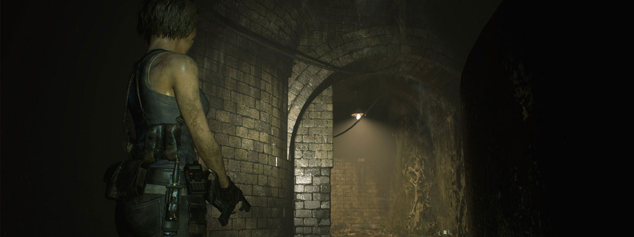 Jill Valentine stands in a dark tunnel with her gun drawn.  