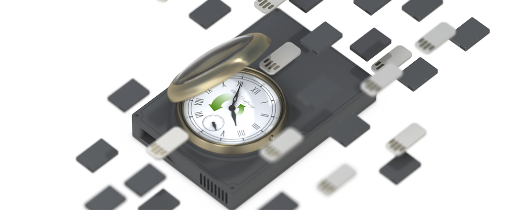  An opened pocket watch, on top of a clipart of an external HDD enclosure. Around them are floating clipart of USB thumb drives and miniaturized HDD enclosures  