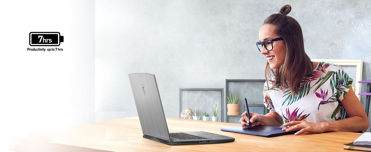 A girl is drawing on a tablet while looking at the display of a laptop