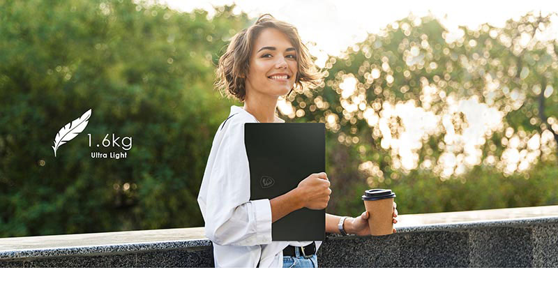 A Woman Carry the Notebook to Show Its Lightweight.