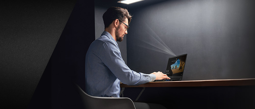 a man is working in front of the laptop