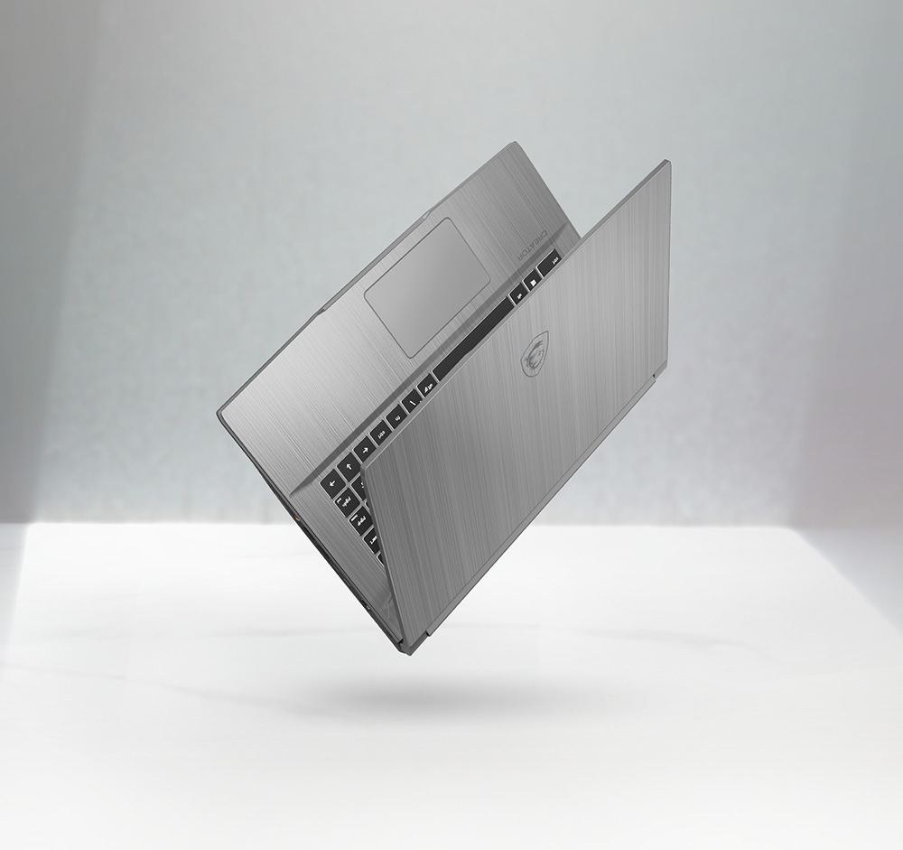 Angled view of Creator 15M, slidely opened to show its thin and lightweight. 