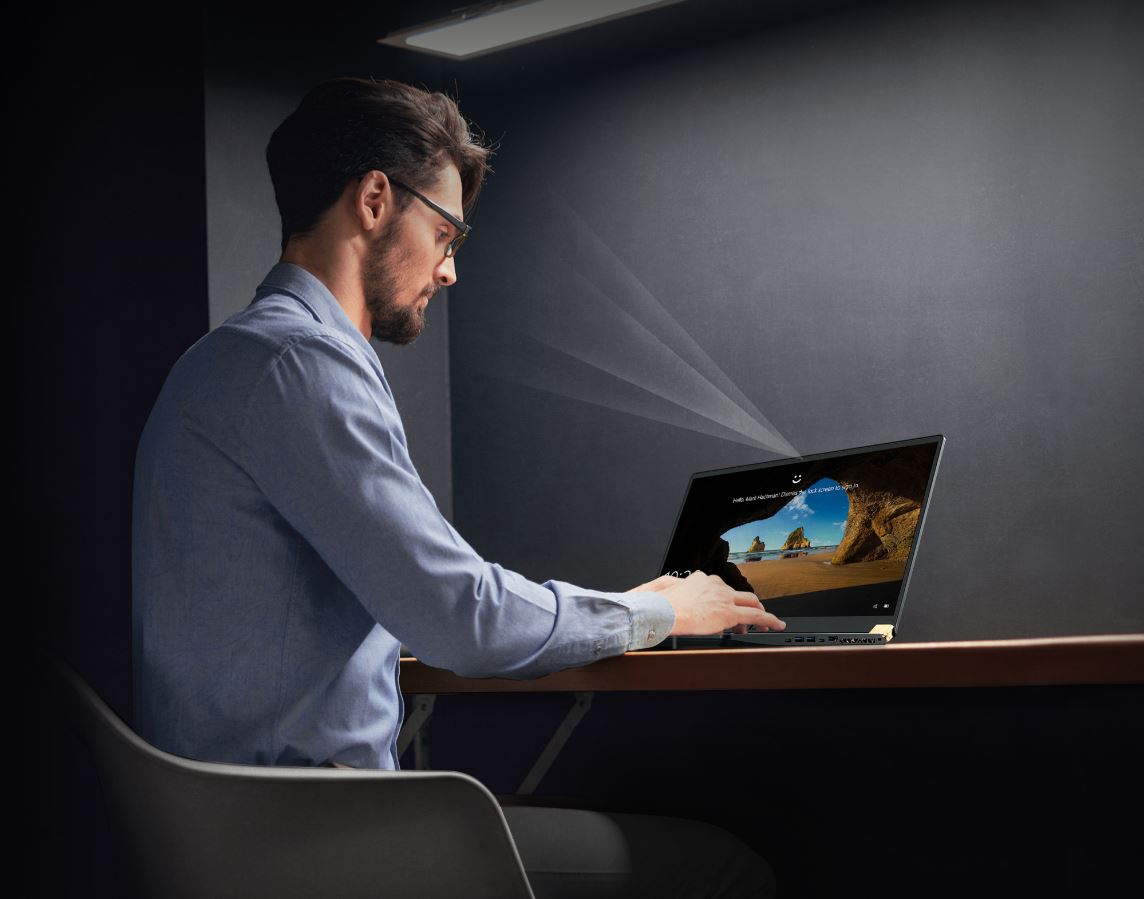 A man is using Windows Hellow via camera.