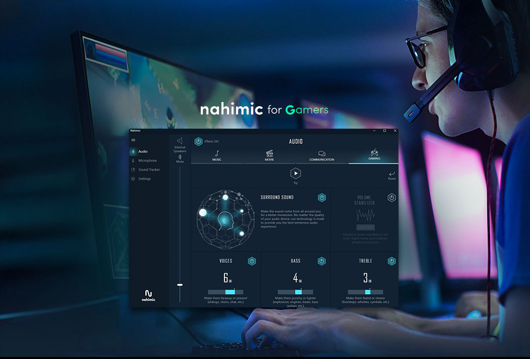 A man wearing a headset gaming on a gaming monitor, keyboard and mouse. The nahimic for gamers software window is open in the forefront of this image