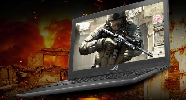 The ASUS ROG Strix GL703 open showing a soldier with an m4 assault rifle and a burning city in the background
