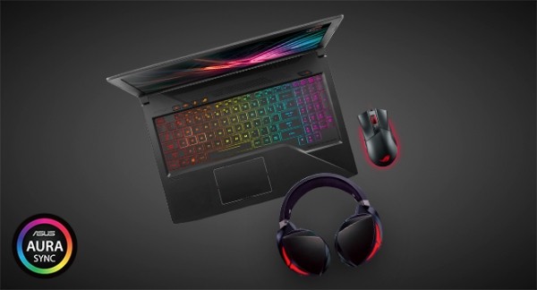 Overhead view of the ASUS ROG Strix laptop open along with a pair of headphones and an ASUS gaming mouse