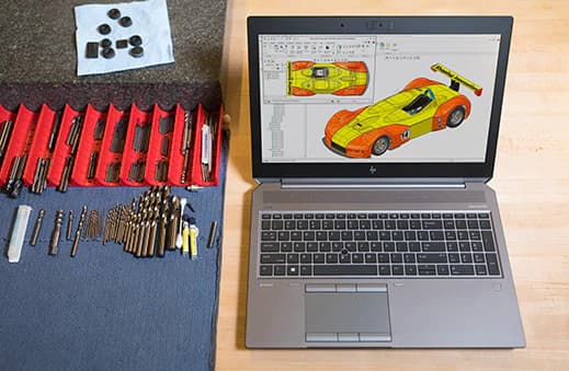 Open Laptop Next to a Designer's Table