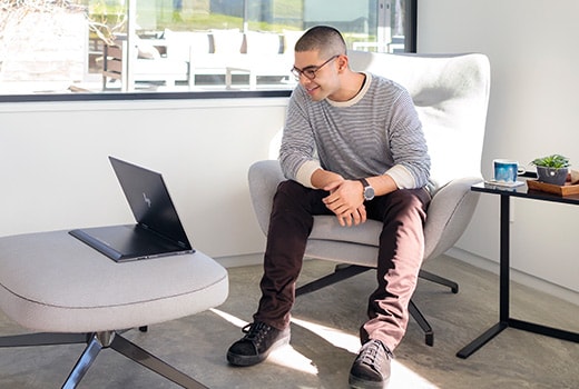 A man in a chair viewing the HP ENVY in viewing mode